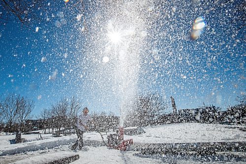 Daniel Crump / Winnipeg Free Press. Mitchell Ketler operates a snowblower as he and his friends help to clear snow from the skatepark at the Forks on Saturday afternoon. March 19, 2022.