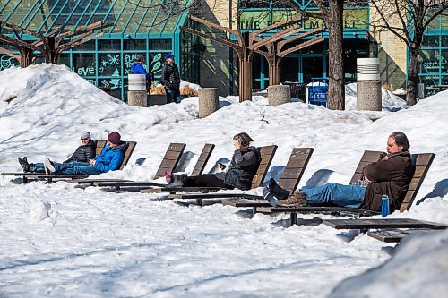 Daniel Crump / Winnipeg Free Press. People sit in the sun and enjoy the warm pre-spring weather in Saturday afternoon at the Forks in Winnipeg. March 19, 2022.