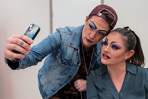 Cory Kukurudz, left, and Kelly DeRoo take a photo of their final drag makeup look during a drag workshop at the Art Gallery of Southwestern Manitoba led by local performer Flora Hex Saturday. (Chelsea Kemp/The Brandon Sun)