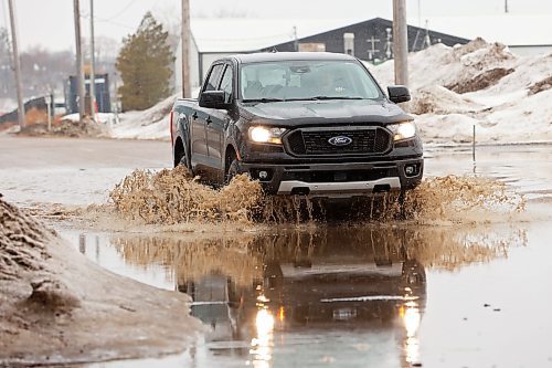 21032022
A motorist makes their way through a deep puddle on Van Horne Avenue East on a rainy and mild Monday afternoon. (Tim Smith/The Brandon Sun)