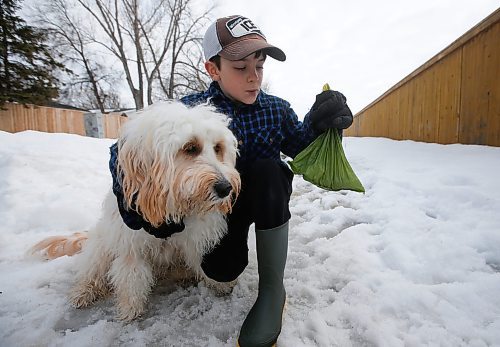 JOHN WOODS / WINNIPEG FREE PRESS
Jake Hultin carries a bag of his puppy Maui&#x2019;s poop as they go for a walk Tuesday, March 22, 2022. Nine year old Hutlin wrote a letter to the city after he noticed that Charleswood is lacking garbage cans for him to drop his doggie bags and litter while out for a walk. Hutlin is asking the city to put out more garbage cans.

Re: Joyanne