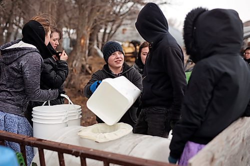 24032022
Children from Deerboine Hutterite Colony collect maple sap from maple trees on the colony Thursday for the first time this year to make maple syrup for use on the colony. For the sap to run the temperature must be cold overnight and warm during the day. (Tim Smith/The Brandon Sun)