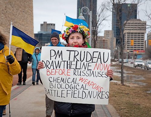 JESSICA LEE / WINNIPEG FREE PRESS

Olga Safroshkina holds a sign near the Human Rights Museum on March 24, 2022 during a protest which called for an end to the Russian invasion of Ukraine.
