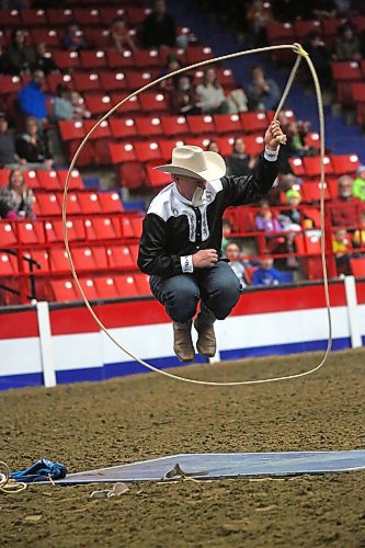 Tom Bishop of Tom Bishop's Wild West Show jumps through a lasso during a performance on Monday afternoon, the opening day of the Royal Manitoba Winter Fair. (Matt Goerzen/The Brandon Sun)