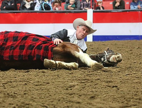 Tom Bishop of Tom Bishop's Wild West Show pretends to nap with his horse during a performance on Monday afternoon, the opening day of the Royal Manitoba Winter Fair. (Matt Goerzen/The Brandon Sun)
