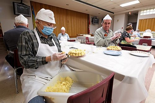 MIKE DEAL / WINNIPEG FREE PRESS
Tony Schoylas (left) and Les Lalchun (right) make little balls of mashed potato that will go inside the perogies.
Holy Eucharist operates a year-round Perogy Hotline to raise funds for the church. Amid the crisis in Ukraine, the volunteers have started donating a portion of their proceeds to humanitarian efforts in the country.
see Eva Wasney story
220324 - Thursday, March 24, 2022.