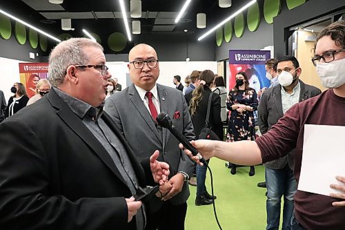 Assiniboine Community College president Mark Frison and Minister of Advanced Education Jon Reyes chat with members of the school's media program following Wednesday's announcement about the opening of two more rural rotating sites for student nurses. (Kyle Darbyson/The Brandon Sun)