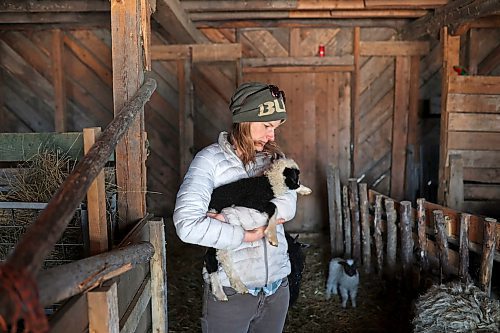 30032022
Mireille Kroeker holds a lamb recently born in the barn at Kroeker and Chris Bevan's small farm in the mostly empty village of Horod, Manitoba west of Onanole. Kroeker and Bevan raise sheep, chickens, pheasants and guineafowl and have pet ducks and a pair of cows. Their sheep recently lambed and will be sheared in the coming weeks. 
(Tim Smith/The Brandon Sun)