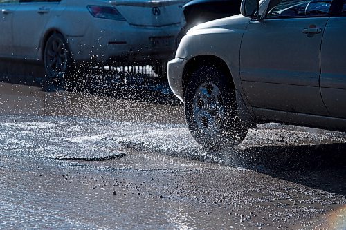 Mike Sudoma / Winnipeg Free Press
A car makes their way over a pot hole and raised pavement going west on Hugo St in Osbourne Village Wednesday
March 30, 2022