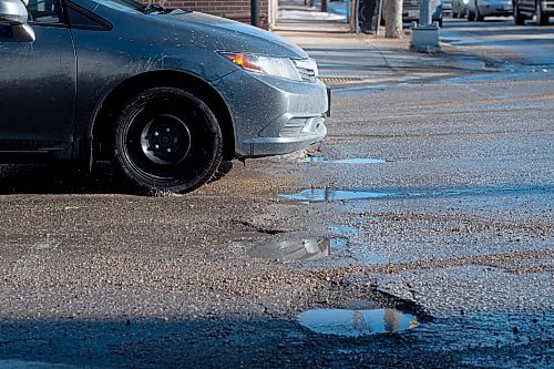 Mike Sudoma / Winnipeg Free Press
A car navigates a number of potholes at the intersection of Grovesnor Ave and Stafford St Wednesday evening
March 30, 2022