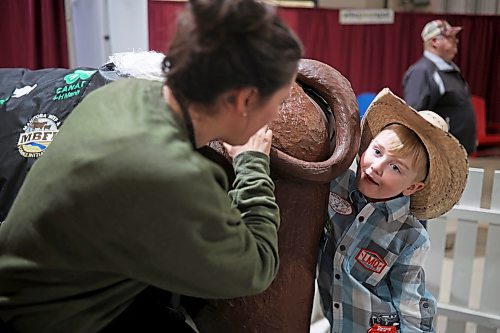31032022
Carter Trann, seven, feels around inside a model of a cow for babies during the Royal Manitoba Winter Fair on Thursday. 
(Tim Smith/The Brandon Sun)