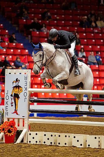 Andrew Curry competes with Ferdinand in the Gamblers Choice Hunter Jumper competition during the First Night of the Royal Manitoba Winter Fair Monday. (Chelsea Kemp/The Brandon Sun)