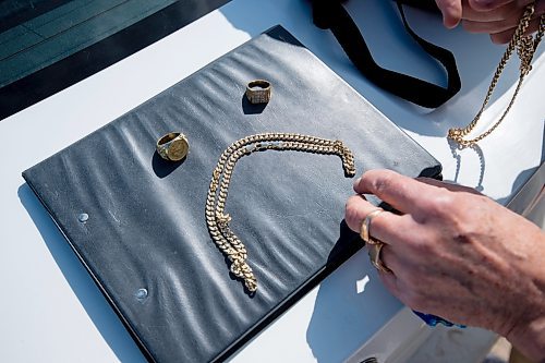 Mike Sudoma / Winnipeg Free Press
Retired school teacher, Gene Kirichenko, arranges the fake gold jewelry in the formation of a sad face after being conned out of $600 last week 
April 1, 2022