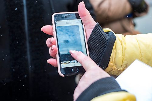 MIKAELA MACKENZIE / WINNIPEG FREE PRESS

Ukrainian refugee Olha Kuchina shows photos of bombs on her phone while standing in line outside of the Canadian Embassy in Warsaw on Friday, April 1, 2022.  For Melissa story.
Winnipeg Free Press 2022.