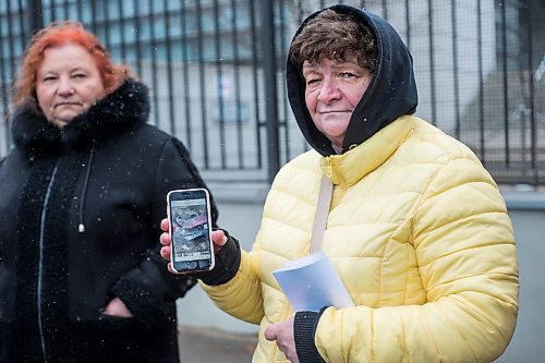 MIKAELA MACKENZIE / WINNIPEG FREE PRESS

Ukrainian refugee Olha Kuchina shows photos of Russian destruction on her phone while standing in line outside of the Canadian Embassy in Warsaw on Friday, April 1, 2022.  For Melissa story.
Winnipeg Free Press 2022.