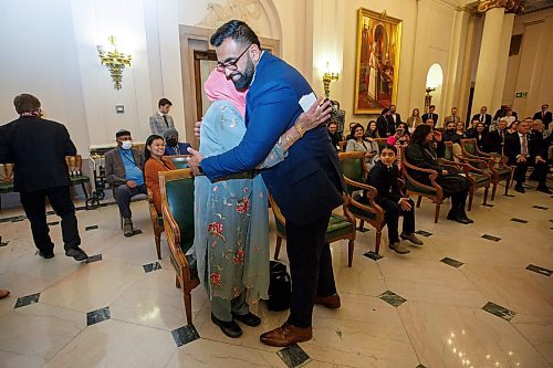 MIKE DEAL / WINNIPEG FREE PRESS
Obby Khan hugs his mother, Rehana Khan, after being sworn in as the provinces first Muslim MLA.
Obby Khan is sworn in by Patricia Chaychuk, clerk of the Legislative Assembly of Manitoba, as the newest MLA for the Manitoba PC Party, Monday morning at the Manitoba Legislative building. Having won the by-election for the Fort Whyte constituency he is the first Muslim elected to Manitoba's Assembly. 
220404 - Monday, April 04, 2022.