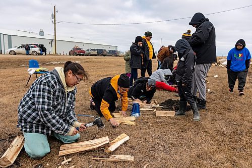 Competitors try their best to start fires using flint and steel during the Dakota Amazing Race at the Wipazoka Wakpa Winter Culture Camp Saturday in Sioux Valley Dakota Nation. (Chelsea Kemp/The Brandon Sun)