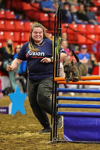 Emily Lowes cheers on a dog during the high jump at the Royal Manitoba Winter Fair Thursday at Westoba Place. (Chelsea Kemp/The Brandon Sun)