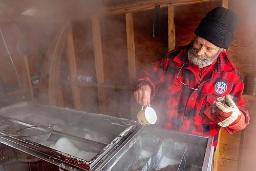 Dave Barnes collects sap to taste in his sugar shack at the Assiniboine Food Forest Saturday. (Chelsea Kemp/The Brandon Sun)