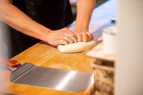 Mike Sudoma / Winnipeg Free Press
Bread maker, Jared Ozuk&#x2019;s gets his hands dirty kneading a batch of dough in his kitchen Wednesday
April 5, 2022