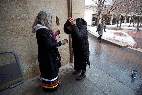 MIKE DEAL / WINNIPEG FREE PRESS
Carole Frechette (left) from Indigenous Relations Division, City of Winnipeg, provides a smudge for delegate, Rachel Sansregret (left), CEO of the Winnipeg Indigenous Friendship Centre, prior to entering the council chambers at City Hall. 
See Joyanne Pursaga story
220406 - Wednesday, April 06, 2022.