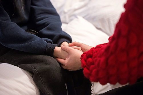 MIKAELA MACKENZIE / WINNIPEG FREE PRESS

Nataliia Cherevko and her 11-year-old son, Bohdan Cherevko, show how they hold hands to pray every night before bed in their hotel room in Warsaw on Friday, April 1, 2022. They are waiting in Warsaw for their Canadian visas to come through (so that they can join Nataliia's husband in Manitoba), and prayer is one of the things that gives them strength. For Melissa story.
Winnipeg Free Press 2022.