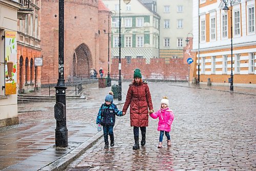 MIKAELA MACKENZIE / WINNIPEG FREE PRESS

Ilona Protynyak, and her children, Demian (five) and Milena (four), go for a walk through the old town in Warsaw on Friday, April 1, 2022. They have been going for long walks to entertain the children, and to give them good memories from this difficult time, while waiting for the Canadian visa paperwork to come through.  For Melissa story.
Winnipeg Free Press 2022.