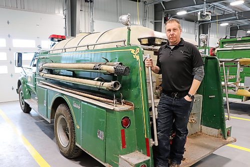 Deputy fire chief Sean Phillips climbs on to the back of a modified 1967 GMC 960 truck on Wednesday evening. This vehicle currently serves as a water tanker for the Killarney-Turtle Mountain Fire Department and is capable of storing over 1000 imperial gallons. (Kyle Darbyson/The Brandon Sun)