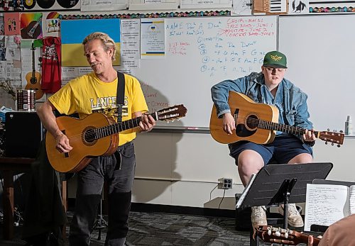 JESSICA LEE / WINNIPEG FREE PRESS

Ric Schulz (in yellow) is a long-time guitar teacher and champion for expanding music education across Manitoba schools. He is photographed in his classroom at Dakota Collegiate during class on June 3, 2022 alongside his student Russel Cormormier.

Reporter: Maggie Macintosh



