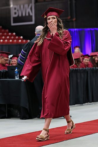 03062022
Practical Nursing Diploma graduate Charity Dueck blows a kiss to someone in the crowd after receiving her diploma from ACC President Mark Frison during Assiniboine Community College&#x2019;s 2022 graduation ceremony at Westoba Place on Friday. 
(Tim Smith/The Brandon Sun)