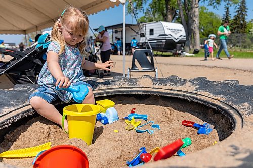 Evie Penner, 2, plays in the sandbox during Touch-a-Truck at the Keystone Centre grounds Saturday. (Chelsea Kemp/The Brandon Sun)