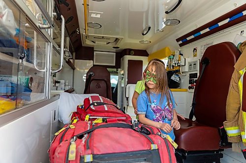Coraline Pakulak, 6, checks out the gear in an ambulance during Touch-a-Truck at the Keystone Centre grounds Saturday. (Chelsea Kemp/The Brandon Sun)