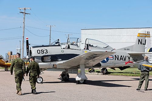A couple members of the military walk by some of the vintage aircrafts that were on display at the Commonwealth Air Training Plan Museum for this year's Canadian Armed Forces Day celebration in Brandon. (Kyle Darbyson/The Brandon Sun)