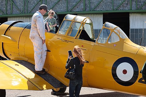 Commonwealth Air Training Plan Museum volunteer Al McNarry shows Torin Husbands and his mother Audra the inside of a 1940 North American Harvard Mark II on Sunday morning in Brandon. The museum hosted a variety of families and vintage aircraft enthusiasts on Sunday to celebrate Canadian Armed Forces Day. (Kyle Darbyson/The Brandon Sun)
