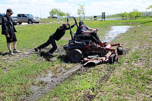 RUTH BONNEVILLE / WINNIPEG FREE PRESS

Local -  Rain / wet weather effects biz 

Photo of maintenance crews at Butler Recreation Park having to push one of their lawn tractors out of a muddy, wet ditch near one of their fields Monday. 

Steve Mymko, facility manager of Buhler Recreation Park: Mymko said this year has been as challenging as any in his 20 years at Buhler Park. He estimated that they have lost around $80,000 due to cancellations.

For story on rainy spring impacting outdoor recreation businesses. The story talks about lost profit due to the weather. 

Story by Bryce Hunt

June 6th, 2022