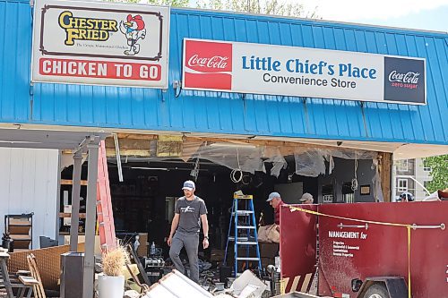 Members of Brandon Maintenance Services clean up the aftermath of an ATM heist that took place at Little Chief's Place on Monday morning, where two adult men tied the machine to the back of their truck and ripped it out of the convenience store. (Kyle Darbyson/The Brandon Sun) 