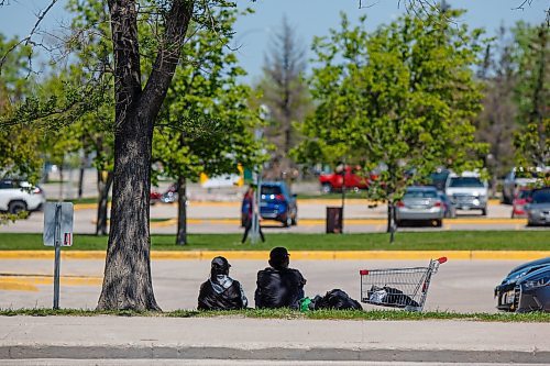 MIKE DEAL / WINNIPEG FREE PRESS
Houseless couple rest in the shade of a tree close to the bus shelter at the corner of Regent Avenue West and Stapon Road.
During Thursday's council meeting, Transcona Councillor Shawn Nason will ask the Public Service to dismantle a pair of problem bus shelters located near Kildonan Place Mall. 
See Tyler Searle story
220607 - Tuesday, June 07, 2022.