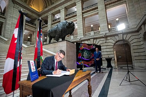 Daniel Crump / Winnipeg Free Press. Mayor Brian Bowman signs the book of condolences commemorating Queen Elizabeth II at the Manitoba legislature in Winnipeg. September 8, 2022.