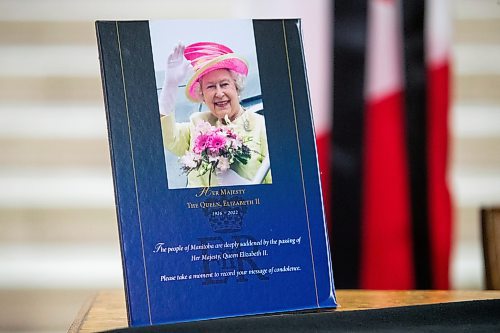 Daniel Crump / Winnipeg Free Press. A placard invites people to take a moment to sign the book of condolences commemorating Queen Elizabeth II at the Manitoba legislature in Winnipeg. September 8, 2022.