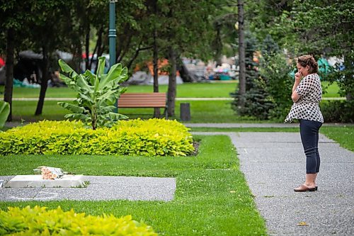 Daniel Crump / Winnipeg Free Press. A person reacts after placing flowers at the base of where a statue of Queen Elizabeth II once stood in the Queen Elizabeth II gardens next to Government House of Manitoba in Winnipeg. The Queen, Englands longest reigning monarch, passed away at her residence in Balmoral, Scotland, earlier today. September 8, 2022.