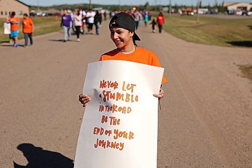 09092022
Toni-Lee Legarde carries a sign while walking in the Suicide Awareness Walk at Sioux Valley Dakota Nation on Friday. The goal of the walk was to raise suicide prevention awareness, to bring attention to supports for those struggling and to support families who have been affected by losing loved ones. Speakers addressed participants before and after the walk.  (Tim Smith/The Brandon Sun)
