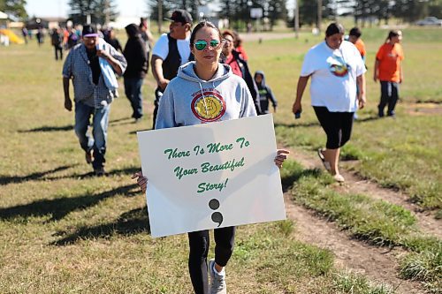 09092022
Melissa Houle, the Physical Education teacher for Sioux Valley High School, carries a sign while walking in the Suicide Awareness Walk at Sioux Valley Dakota Nation on Friday. The goal of the walk was to raise suicide prevention awareness, to bring attention to supports for those struggling and to support families who have been affected by losing loved ones. Speakers addressed participants before and after the walk.  (Tim Smith/The Brandon Sun)
