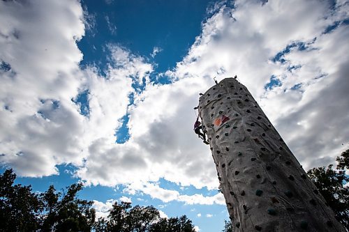 Daniel Crump / Winnipeg Free Press. Zach Gerbrandt climbs the Vertical Adventures portable climbing wall at Manyfest in Winnipeg, Saturday afternoon. September 10, 2022.