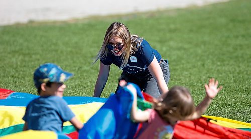 JOHN WOODS / WINNIPEG FREE PRESS
Katie Hurst, co-organizer of event and teacher, plays a game with children at a People For Public Education picnic at the Forks Sunday, September 11, 2022. 

Re: