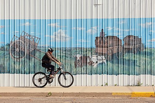12092022
A cyclist rides past a mural on the side of a building in downtown Neepawa on a hot Monday afternoon.  (Tim Smith/The Brandon Sun)
