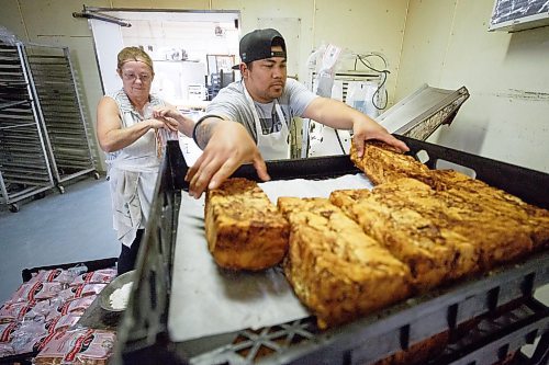 MIKE DEAL / WINNIPEG FREE PRESS
Bags of Apple cinnamon bread are sliced and bagged by cake decorator, Susan Seavers (left), and baker Lester Villa (right). 
Russ Meier, owner of the Donut House, 500 Selkirk Avenue, which has been around in one form or another - OK, mostly round - for 75 years, this year.
220913 - Tuesday, September 13, 2022.