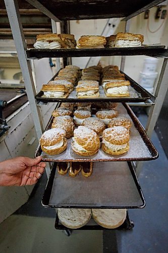 MIKE DEAL / WINNIPEG FREE PRESS
Creme filled delicacy's wait to be boxed up. 
Russ Meier, owner of the Donut House, 500 Selkirk Avenue, which has been around in one form or another - OK, mostly round - for 75 years, this year.
220913 - Tuesday, September 13, 2022.