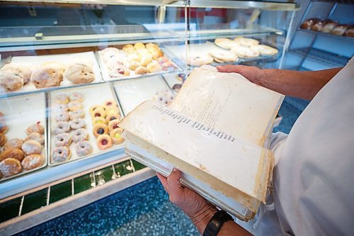 MIKE DEAL / WINNIPEG FREE PRESS
Russ Meier leafs through his dads old recipe book. 
Russ Meier, owner of the Donut House, 500 Selkirk Avenue, which has been around in one form or another - OK, mostly round - for 75 years, this year.
220913 - Tuesday, September 13, 2022.