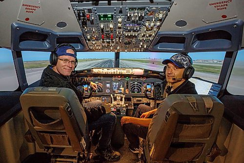 MIKE DEAL / WINNIPEG FREE PRESS
Instructor, Chris Crawley (left) and Yuri Gedgafof (right), co-creator of Pilots Club Winnipeg, in the seats of the 737ng flight simulator.
Pilots Club Winnipeg is launching a Boeing 737 flight simulator to go along with their F18 flight simulator at The Forks in the Johnston Terminal.
220913 - Tuesday, September 13, 2022.