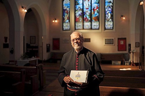 13092022
The Very Reverend William G. Cliff, VII Bishop of Brandon, holds a book of condolence for Her Majesty Queen Elizabeth II at St. Matthew's Anglican Cathedral in Brandon on Tuesday. 
(Tim Smith/The Brandon Sun)